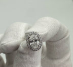 Diamond ring on a white cushion with a light gray background